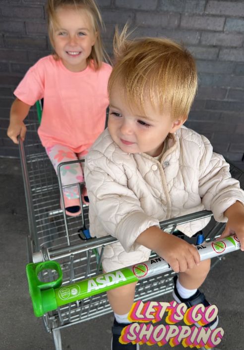 Two children sat in a trolley