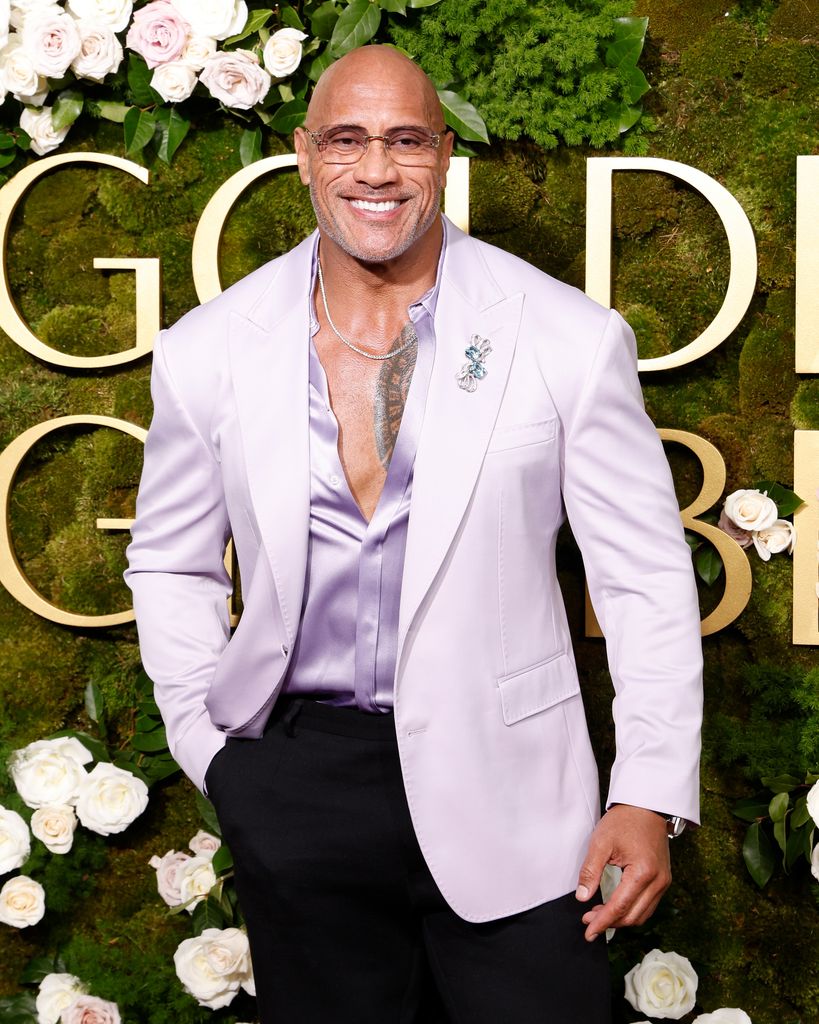 Dwayne Johnson in purple jacket on the red carpet