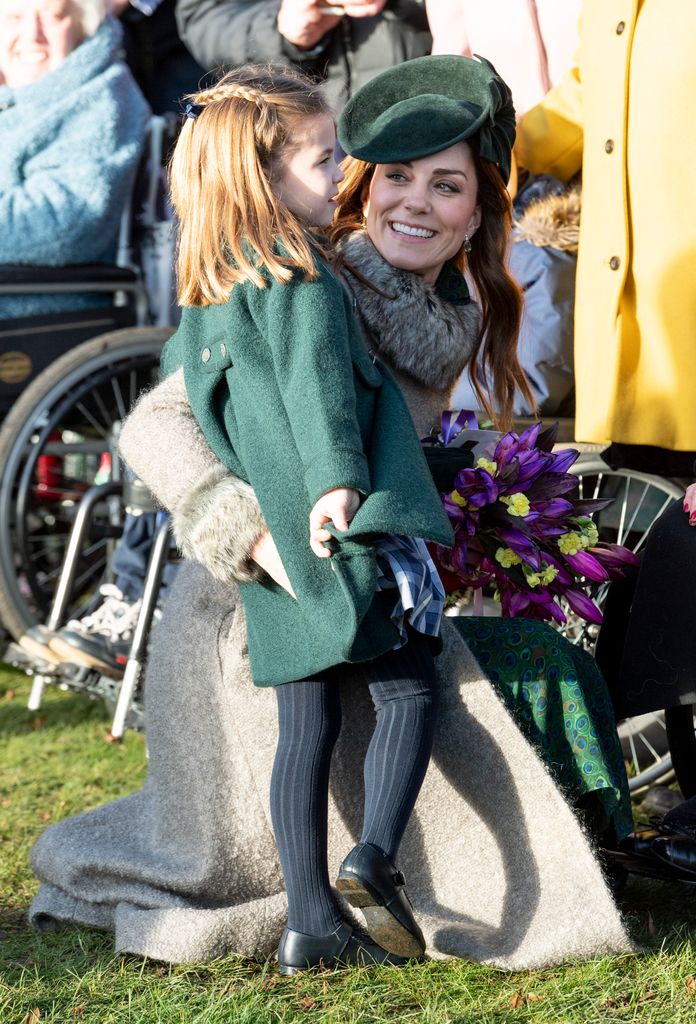 Kate with her arm around Princess Charlotte on Christmas Day