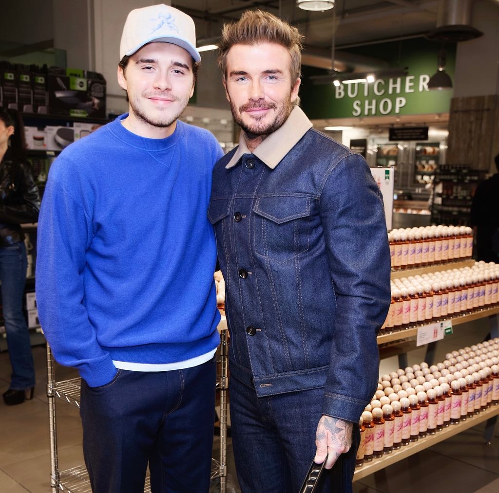 Brooklyn and David Beckham pose for a photo together in matching blue looks 