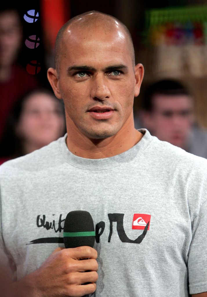  Surfer Kelly Slater holding a microphone 