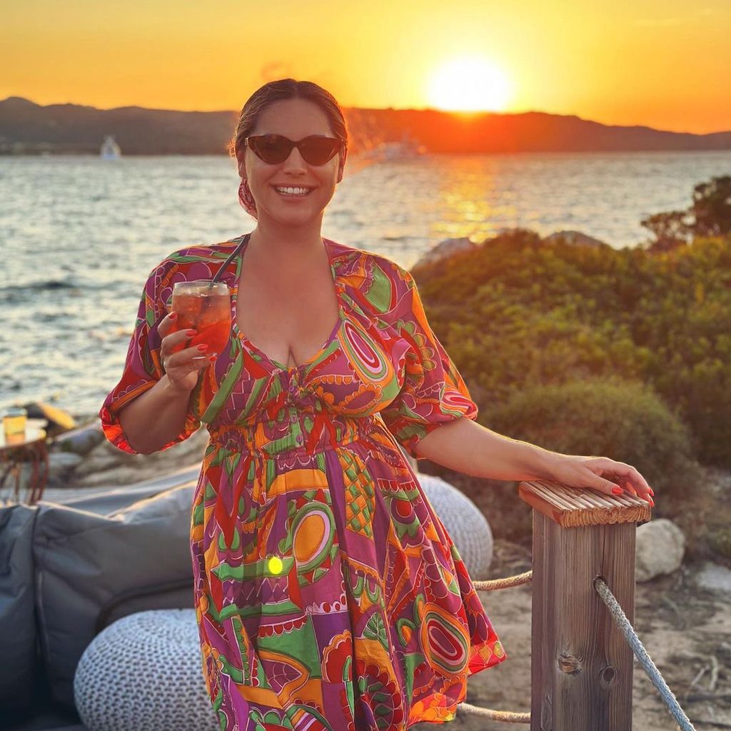Kelly Brook looks gorgeous in floaty dress as sun sets behind her