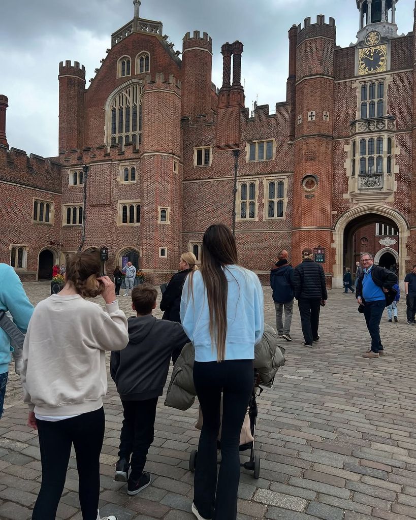 Emily Andre pushing a pram with her two kids standing next to her