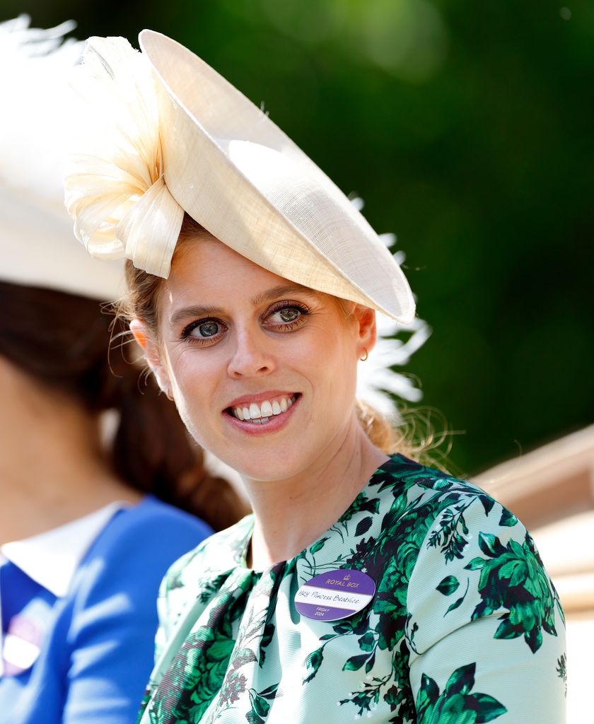 Princess Beatrice smiling in green dress and hat