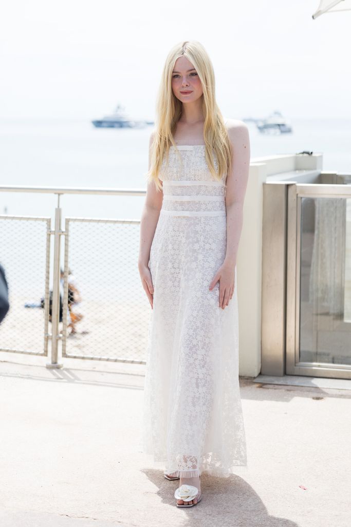 Elle Fanning looked etheral in a white floral maxi dress and white statement rosette heels