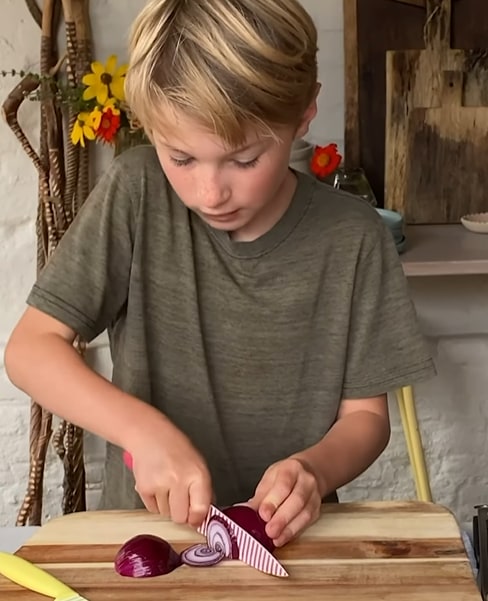 Buddy Oliver cooks in their outdoor kitchen