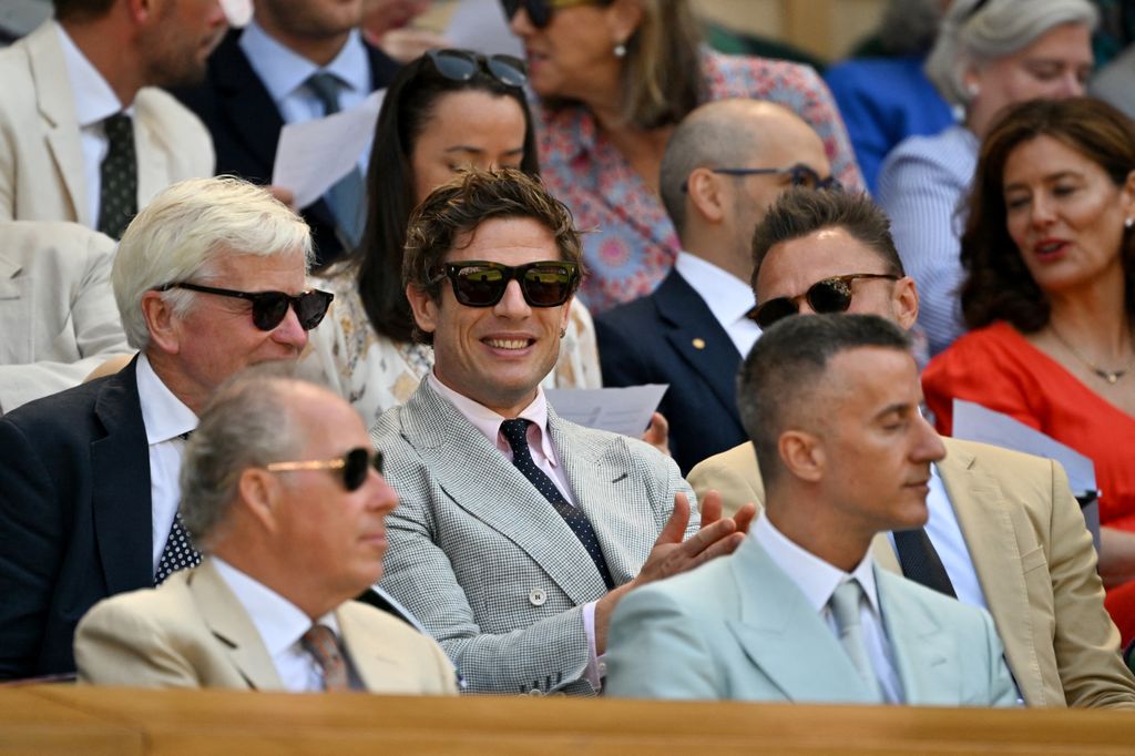 British actor James Norton (C) sits in the Royal Box on Centre Court