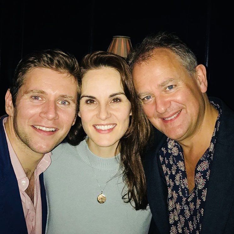 Three people smiling for selfie