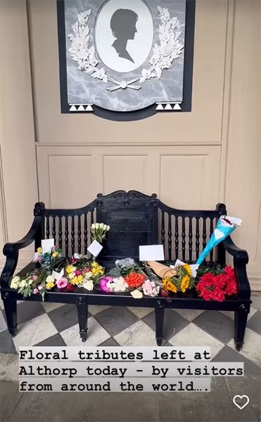 floral tributes on a bench for princess diana