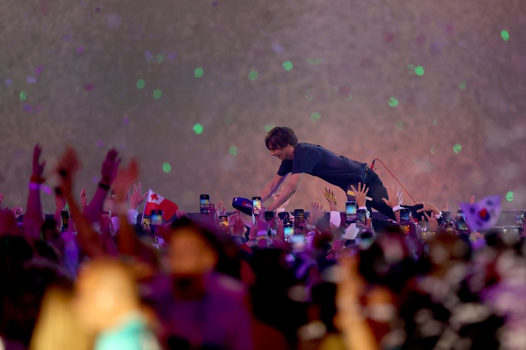 Thomas Mars, lead singer of French Indie rock band Phoenix, high fives fans during the Closing Ceremony of the Olympic Games Paris 2024 at Stade de France on August 11, 2024 in Paris, France.