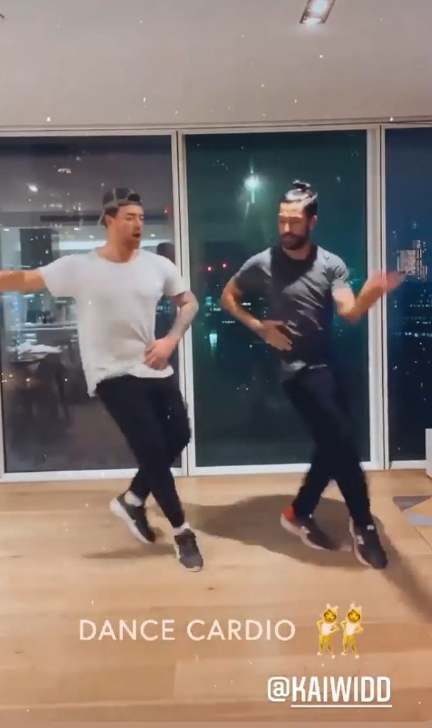 Kai Widdrington and Giovanni Pernice dancing in the kitchen