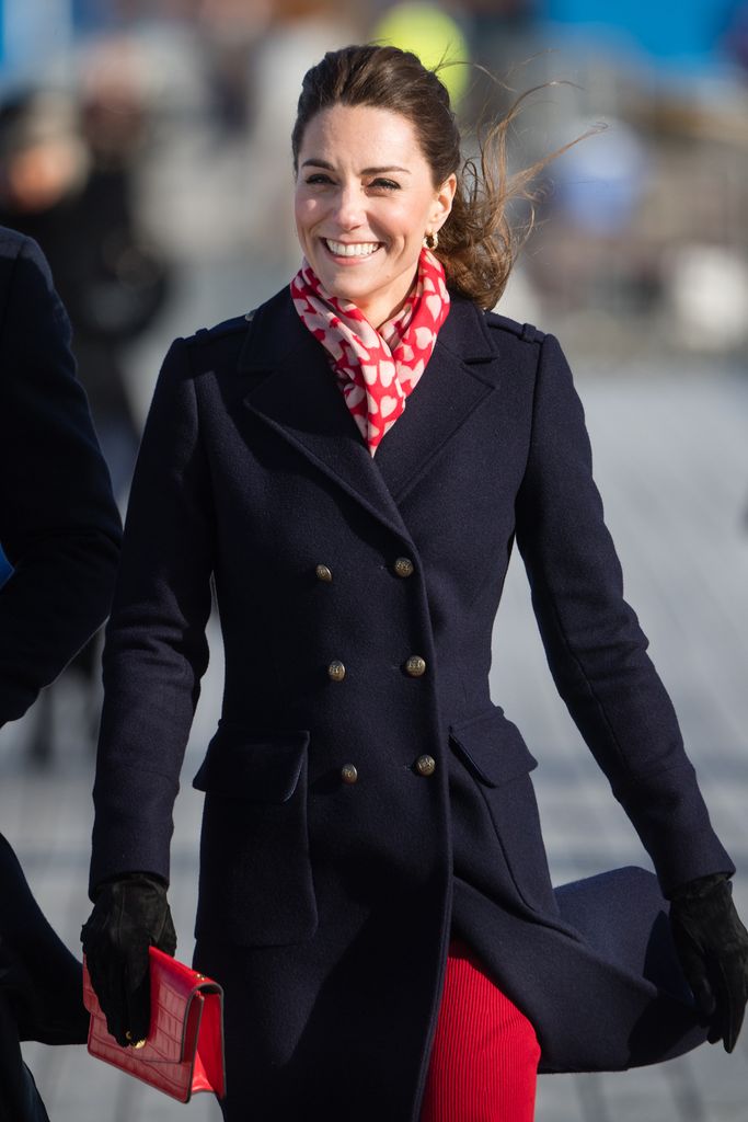 Kate Middleton wearing heart print scarf and navy coat visits Mumbles Pier on February 04, 2020 in Swansea, Wales .