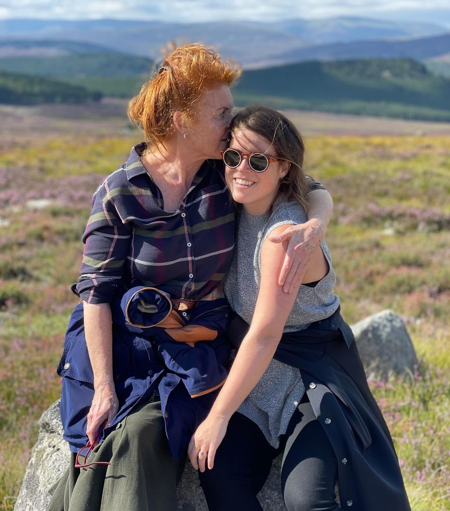 Sarah Ferguson with her arms around Princess Eugenie in the countryside