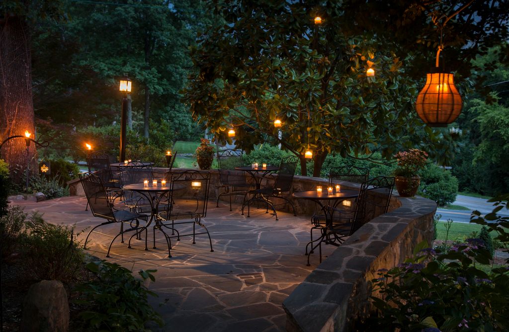 Patio lit with hanging lanterns and candles
