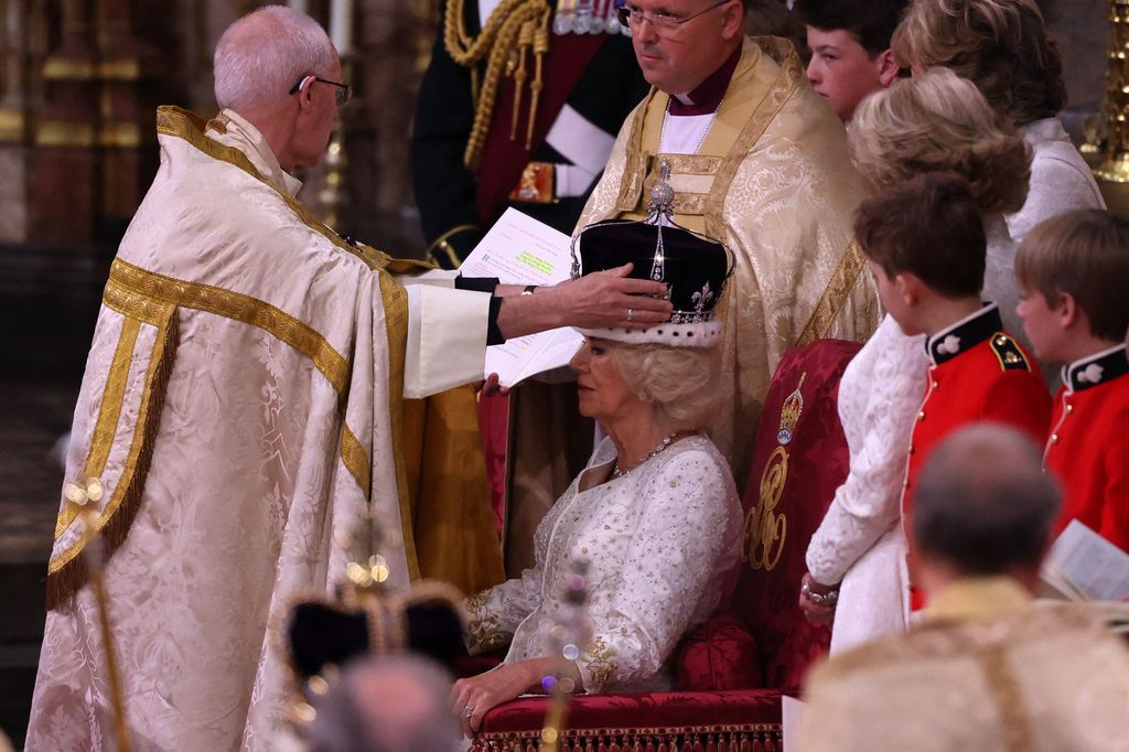 The Archbishop of Canterbury Justin Welby places a modified version of Queen Mary's Crown onto the head of Queen Camilla