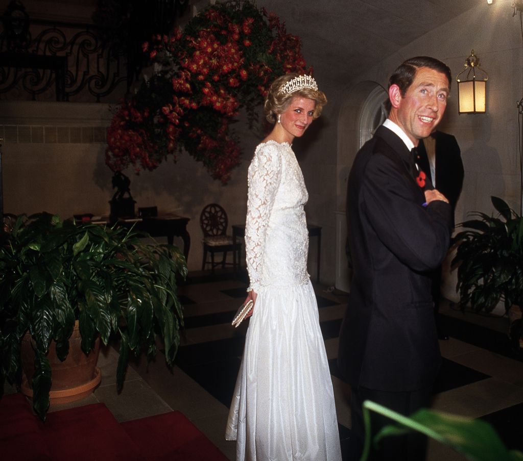 Prince Charles  in a suit and Princess Diana in a white lace dress
