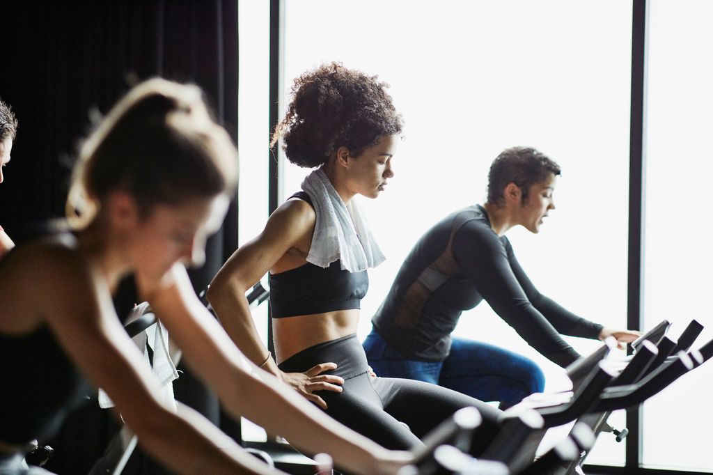 three people on spin bikes 