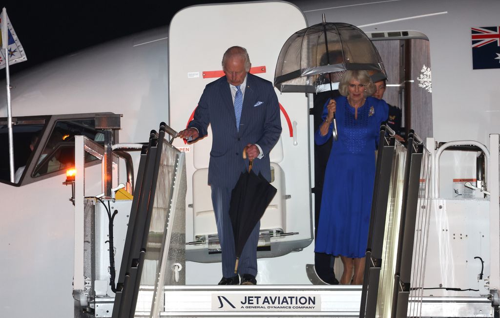 King Charles and Queen Camilla come off plane