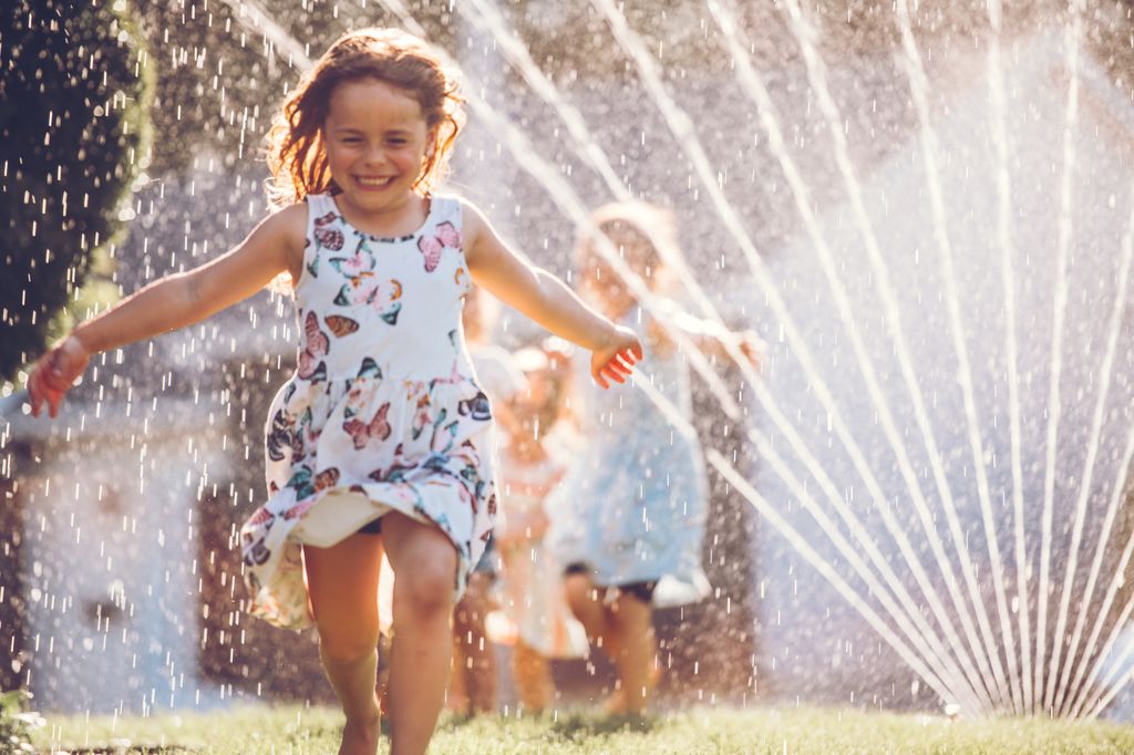 Kids playing with the sprinkler