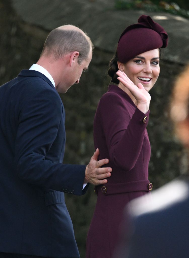 Kate Middleton waving with Prince William placing his hand on her back