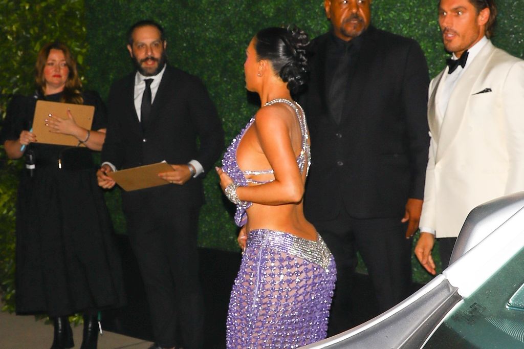 Kim Kardashian stole the spotlight as she arrived at her mother Kris Jennerâs 70th birthday bash in Beverly Hills, wearing a stunning lavender crystal-embellished gown that shimmered under the lights.