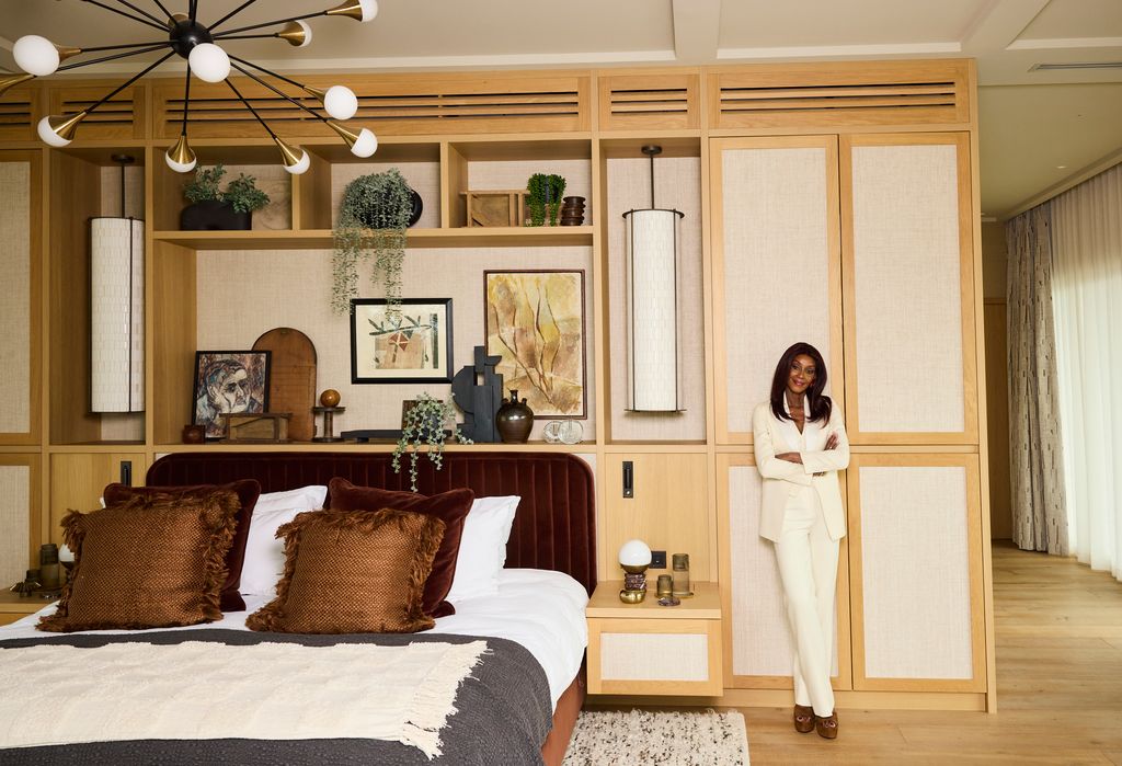 woman in large wood panelled bedroom 