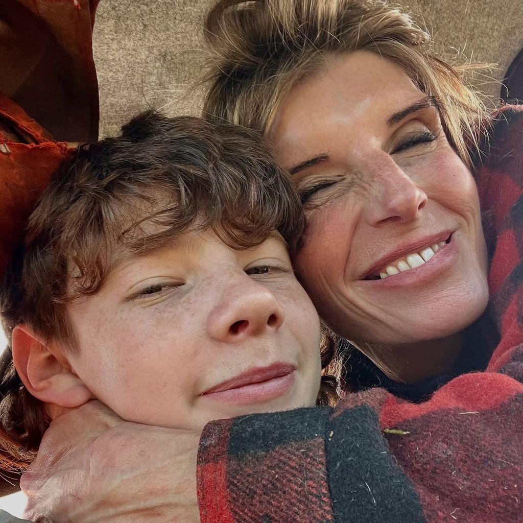 Amanda takes a selfie while cuddling her son