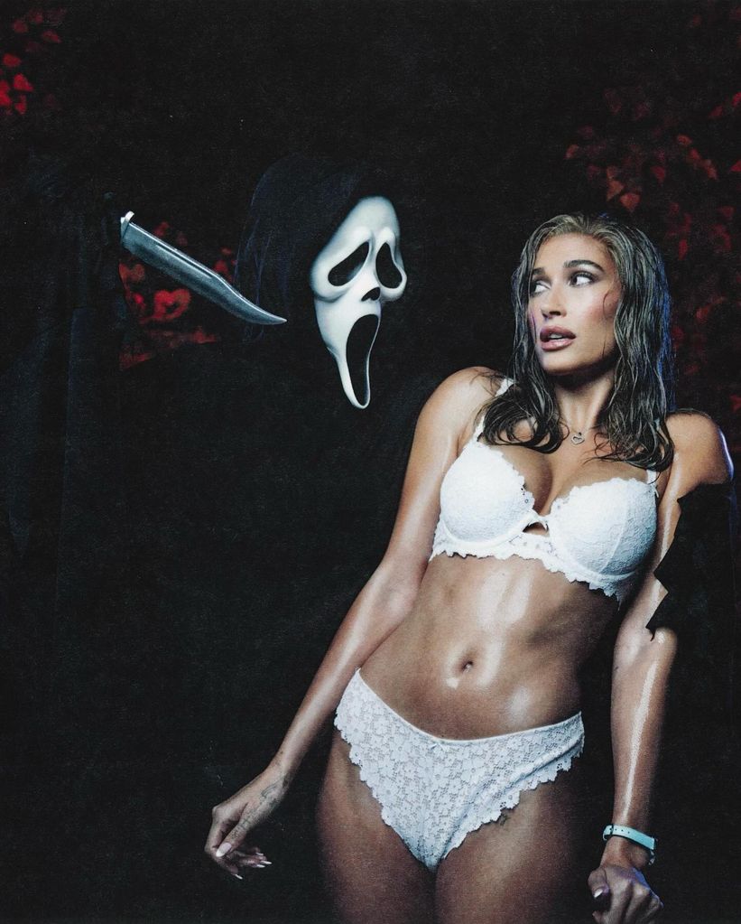 Haily Bieber wears white lingerie and cowers from a Ghostface figure