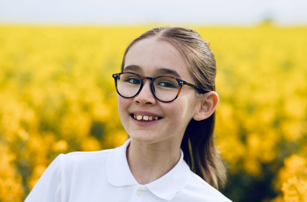 girl smiling in flower field