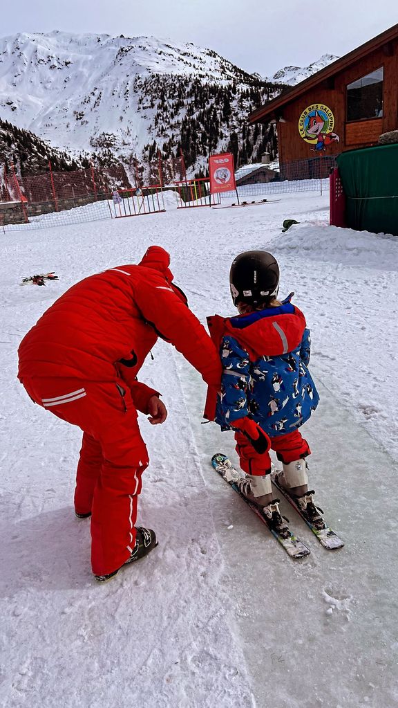 A photo of Boris Johnson helping Wilf with his ski