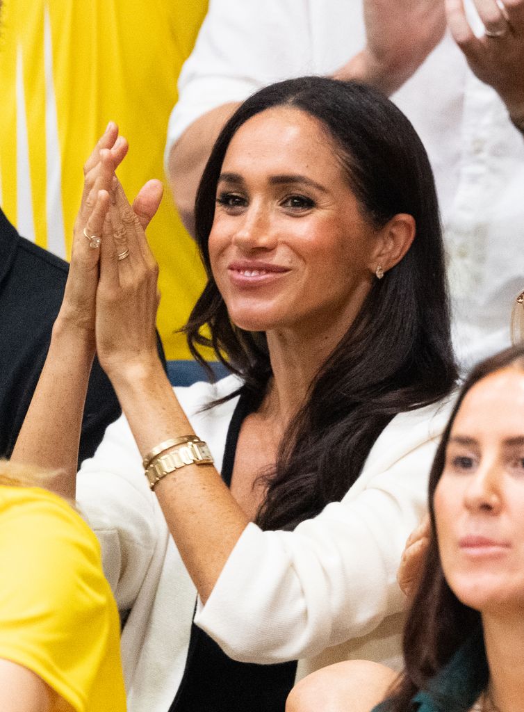 Meghan in crowd clapping