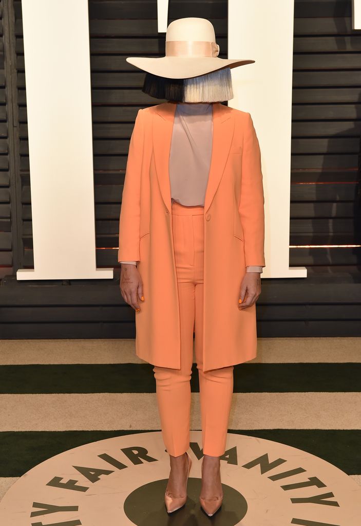 Sia in an orange suit and a wig at the 2017 Vanity Fair Oscar Party