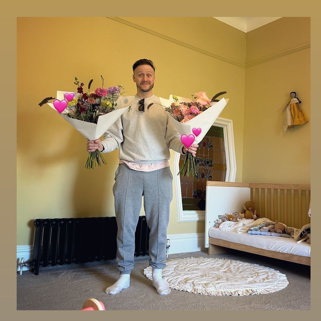 man posing in nursery with two bouquets