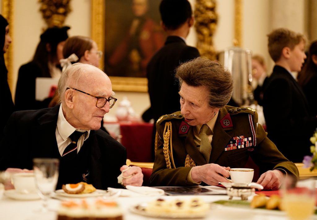 Princess Anne in military attire drinking a cup of tea