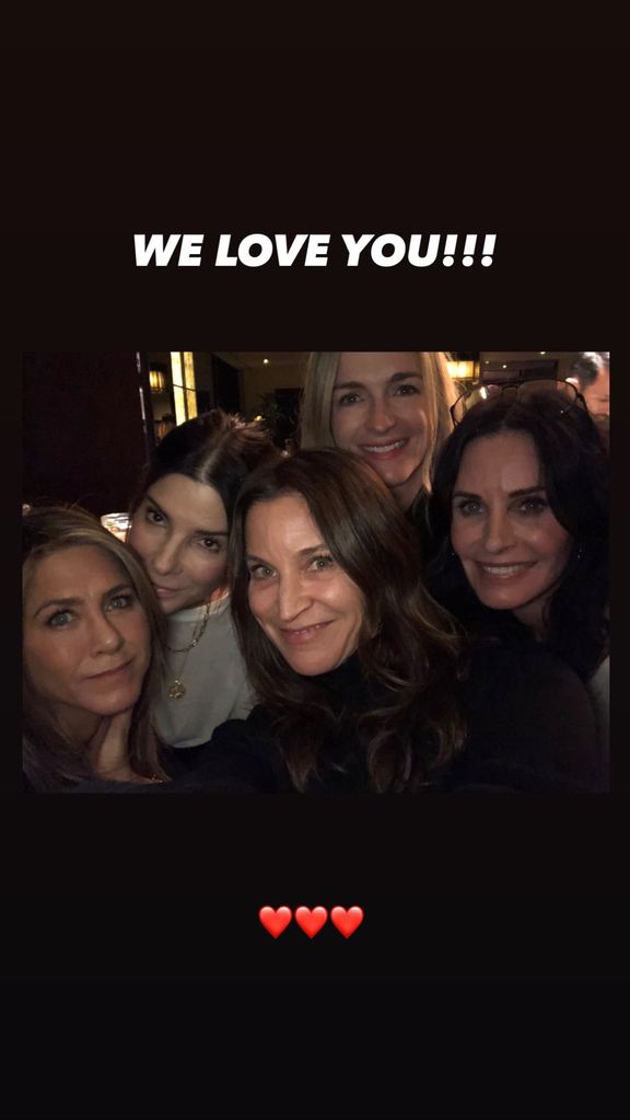 Jennifer Aniston, Courteney Cox, and Sandra Bullock celebrating together in a photo shared on Instagram