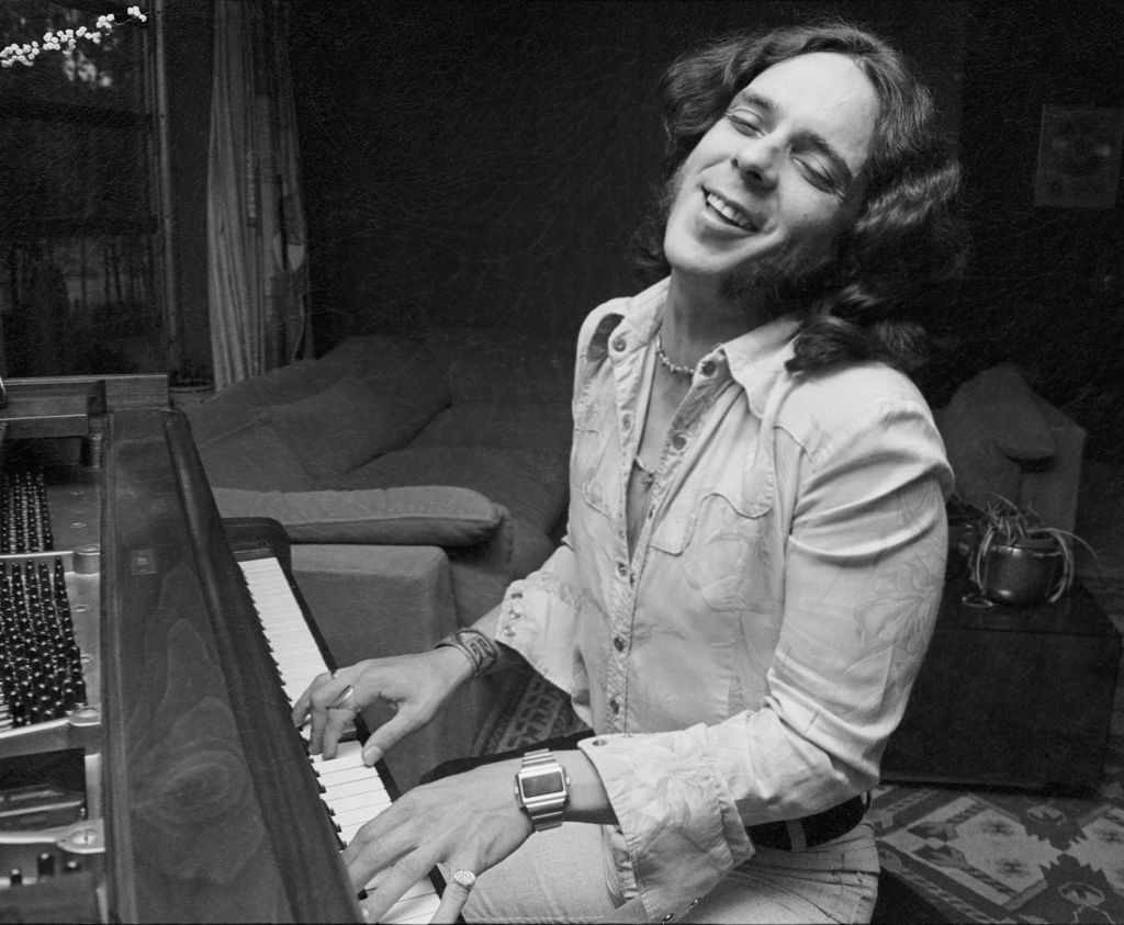 Bobby Whitlock sings and plays the piano in his home.