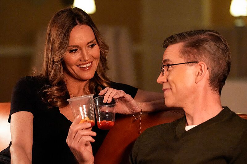 Man and woman clinking glasses