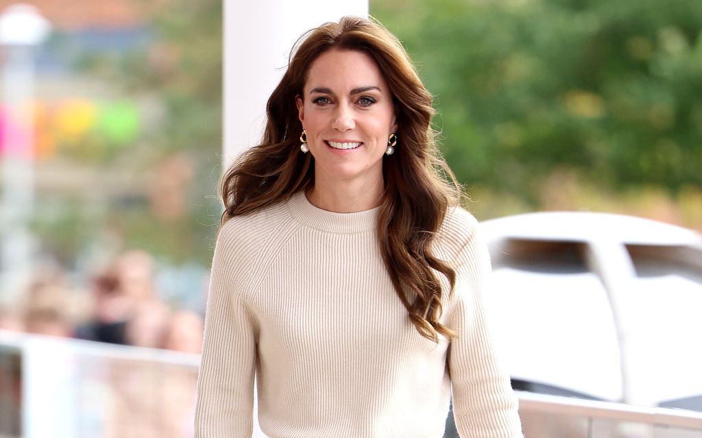 Kate Middleton wearing cream knitwear and pearl earrings