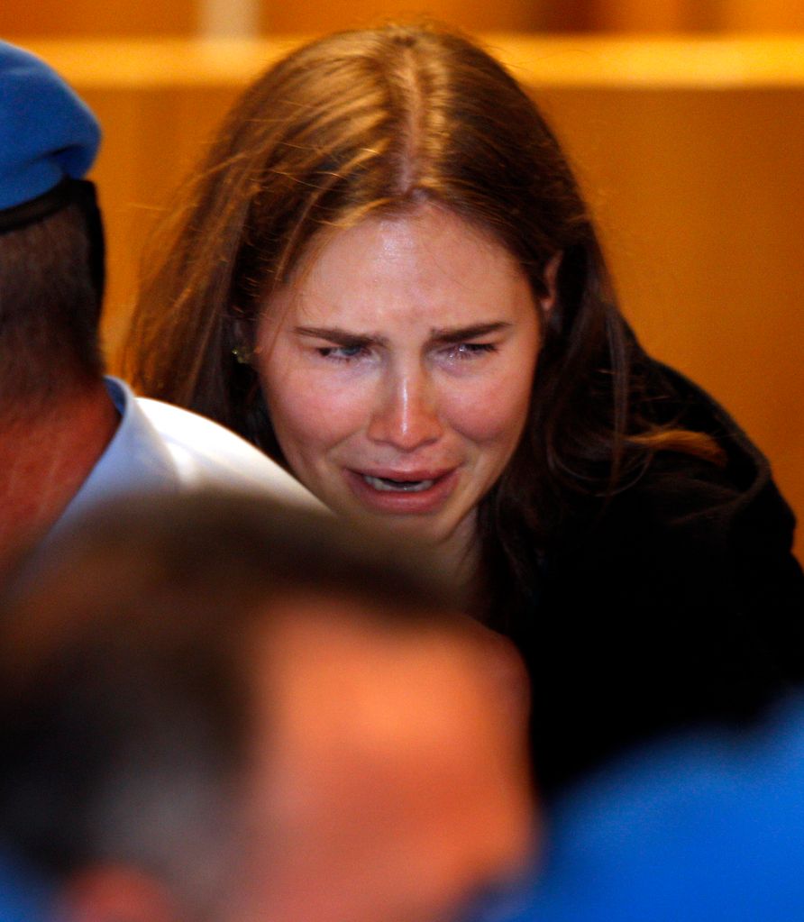 PERUGIA, ITALY - OCTOBER 03: Amanda Knox breaks down in tears after hearing the verdict that overturns her conviction and acquits her of murdering her British roommate Meredith Kercher, at the Perugia court on October 3, 2011 in Perugia, Italy. American student Amanda Knox and her Italian ex-boyfriend Raffaele Sollecito have won their appeal against their conviction in 2009 of killing their British roommate Meredith Kercher in Perugia, Italy in 2007. The pair had served nearly four years in jail after initially being sentenced to 26 and 25 years respectively.  (Photo by Pier Paolo Cito - Pool/Getty Images)