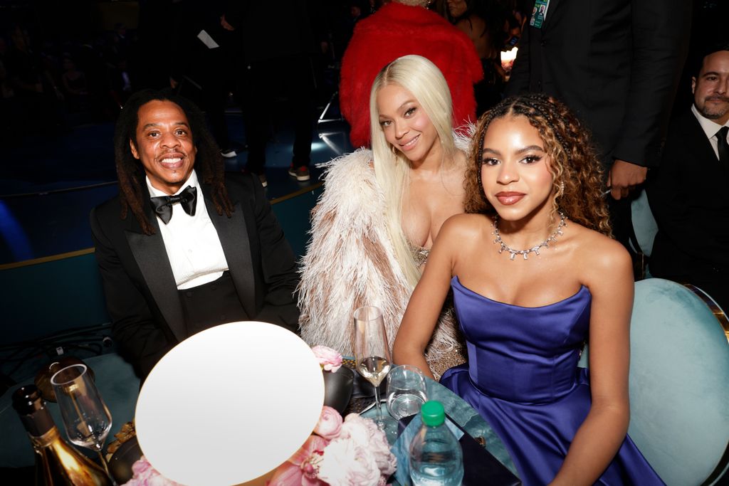 jay z beyonce blue ivy sitting down at table and smiling for camera