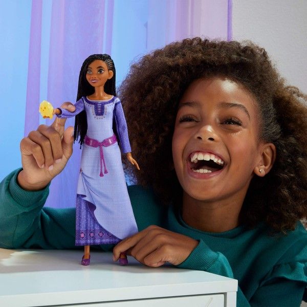 Girl playing with Disney Wish Singing Asha of Rosas Fashion Doll