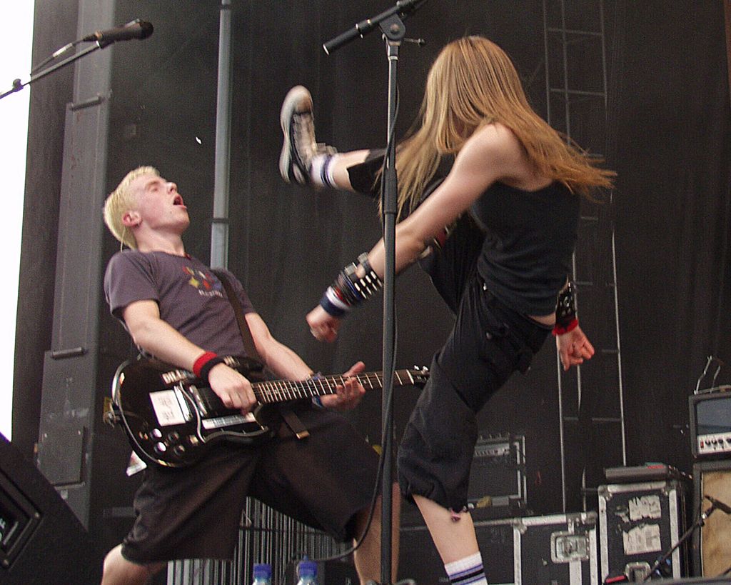 Jesse Colburn performing on stage with Avril