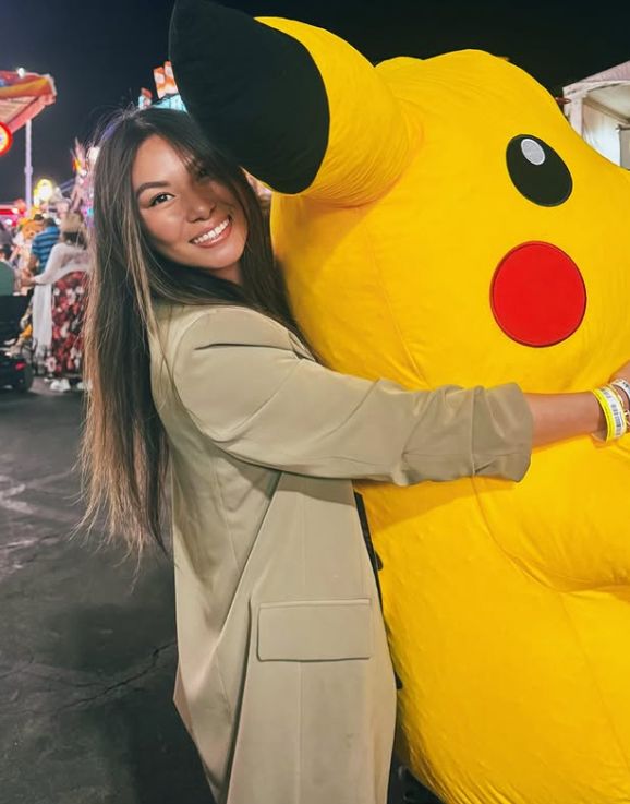 Lucy Guo holding a giant Pikachu plush