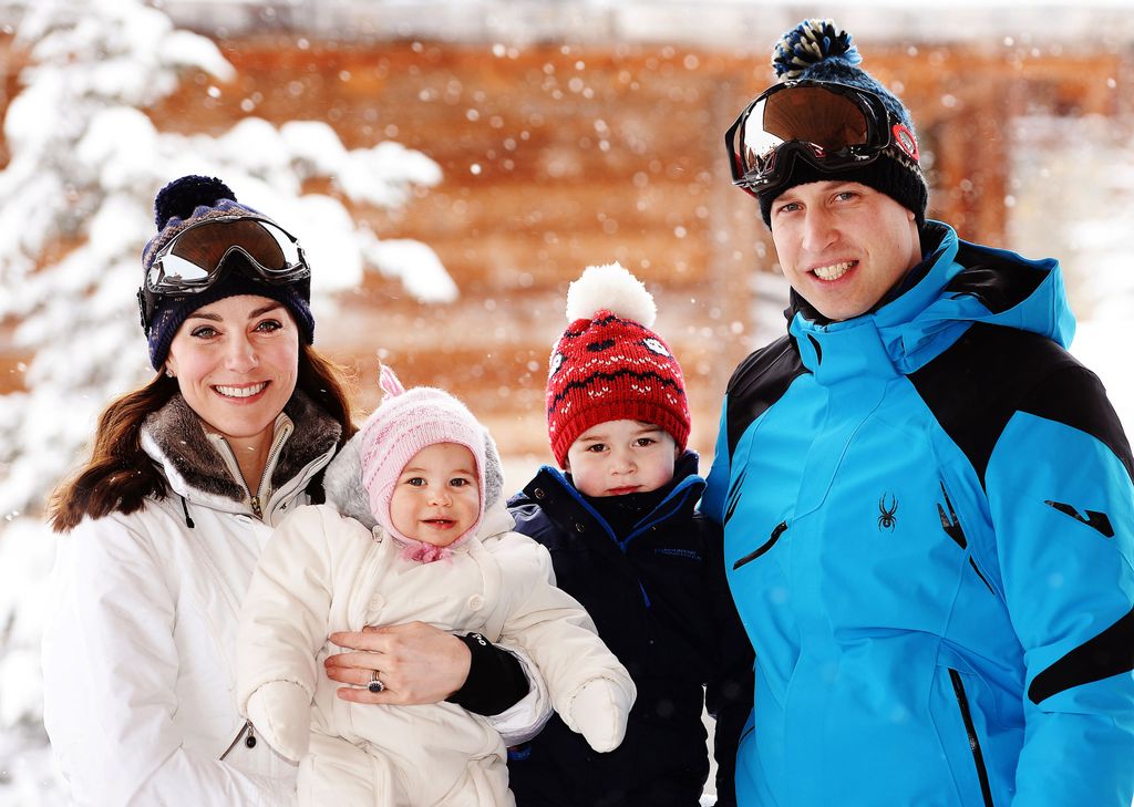 Princess Kate and Princess Charlotte wearing white snow suits