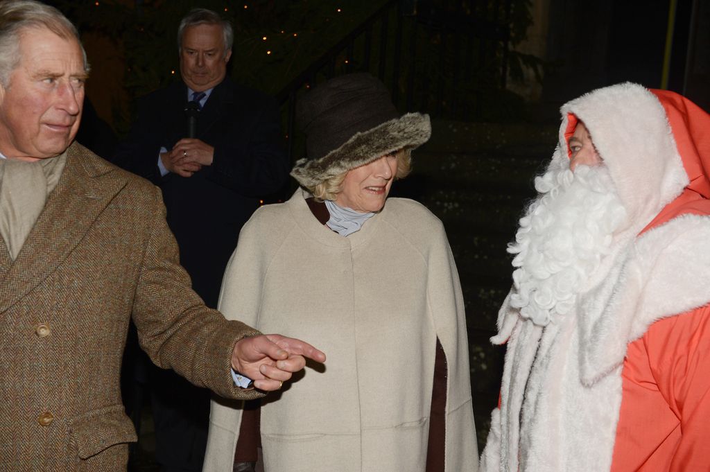 Charles and Camilla meet Father Christmas as they switch on the Christmas lights in Tetbury