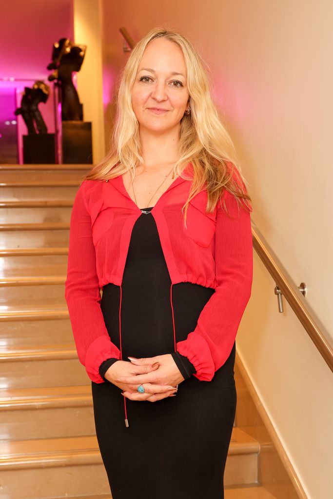 Claire Ptak in a red top and black dress