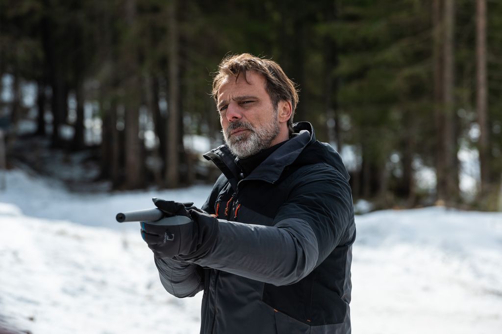 man holding gun in snow