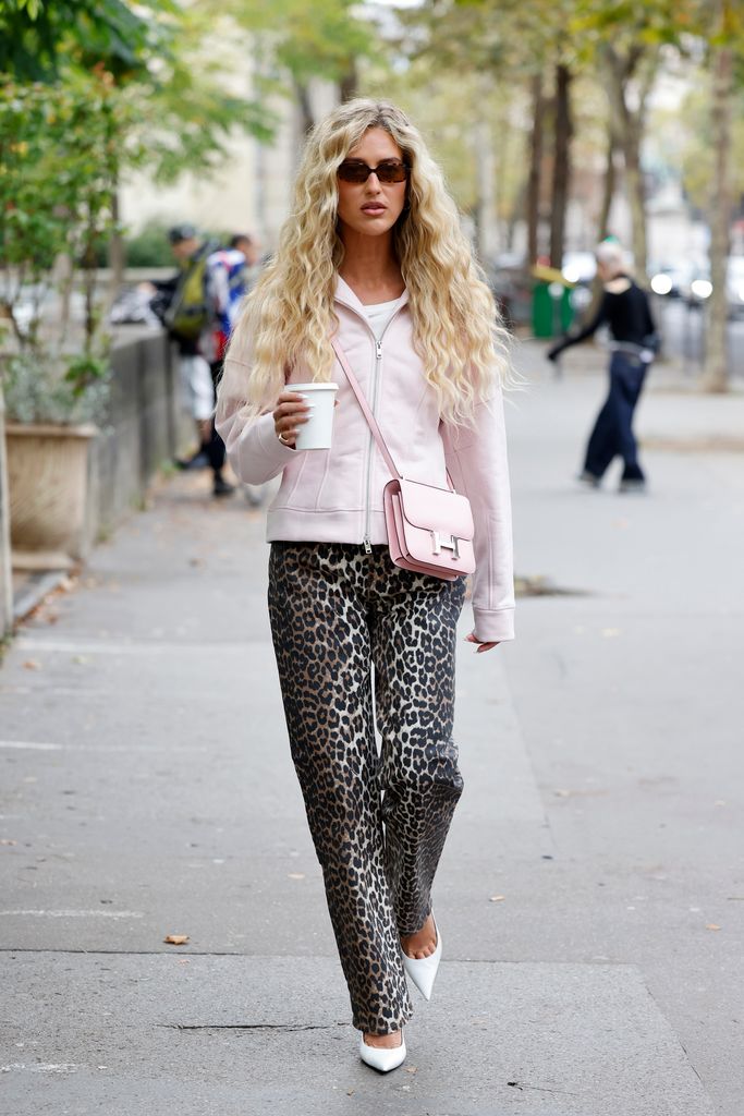 Emili Sindlev spotted during fashion week teaming her white heels with leopard print and baby pink