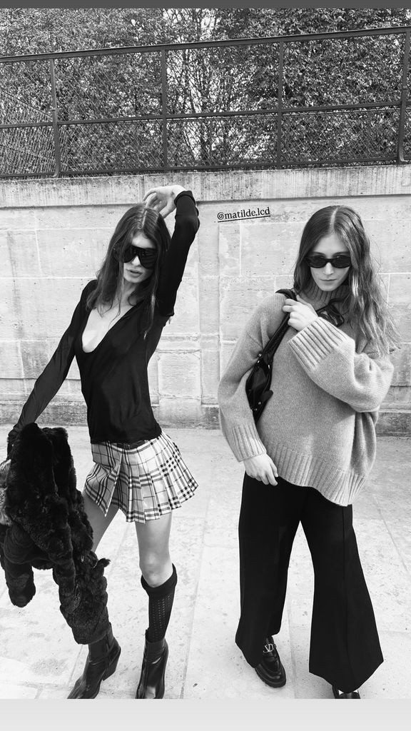 Sunday Rose Kidman wearing knitted sweater and black pants in black and white photo with friend