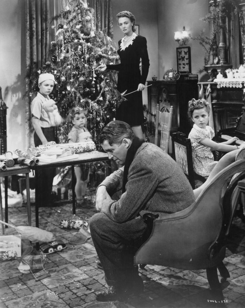 American actors James Stewart (1908 - 1997) and Donna Reed (1921 - 1986) star in the film 'It's a Wonderful Life', 1946. The children are Larry Simms (Peter Bailey), Jimmy Hawkins (Tommy Bailey) and Carol Coombs (Janie Bailey)